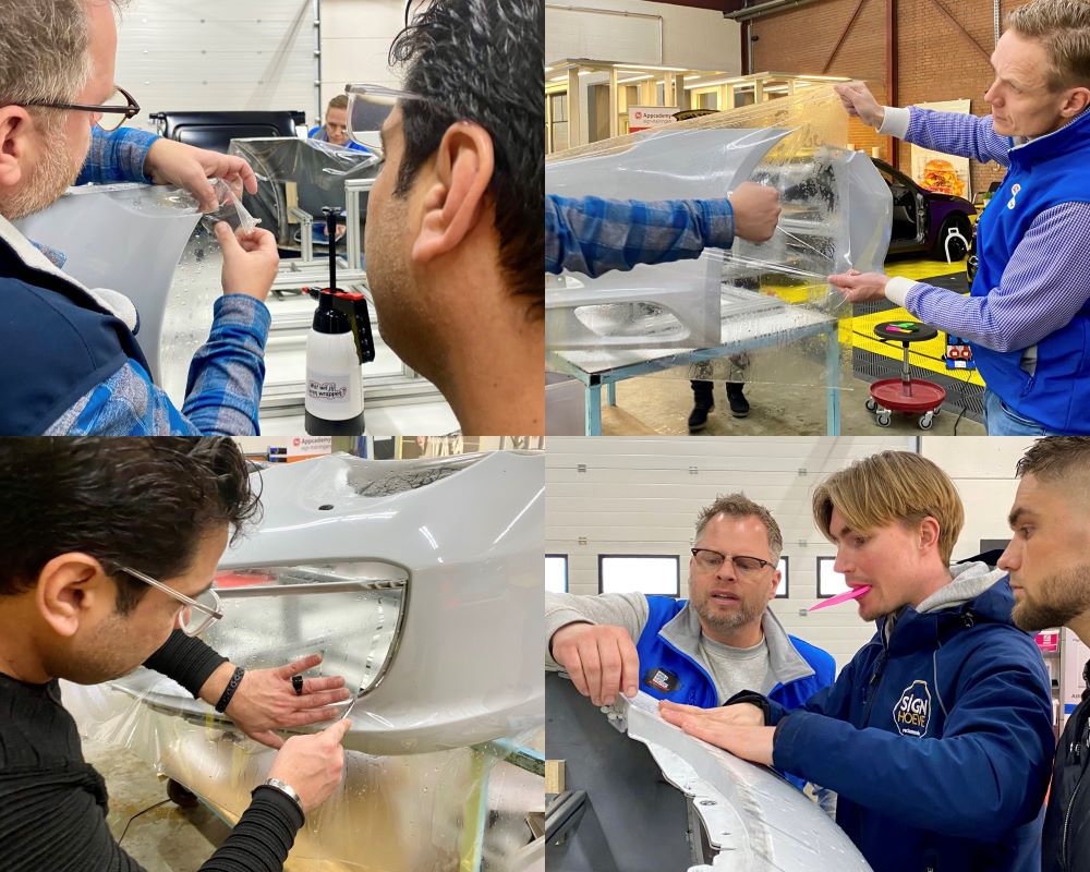 Cursisten appliceren met hulp van trainer PPF op bumper tijdens Appcademy Paint Protection Film cursus