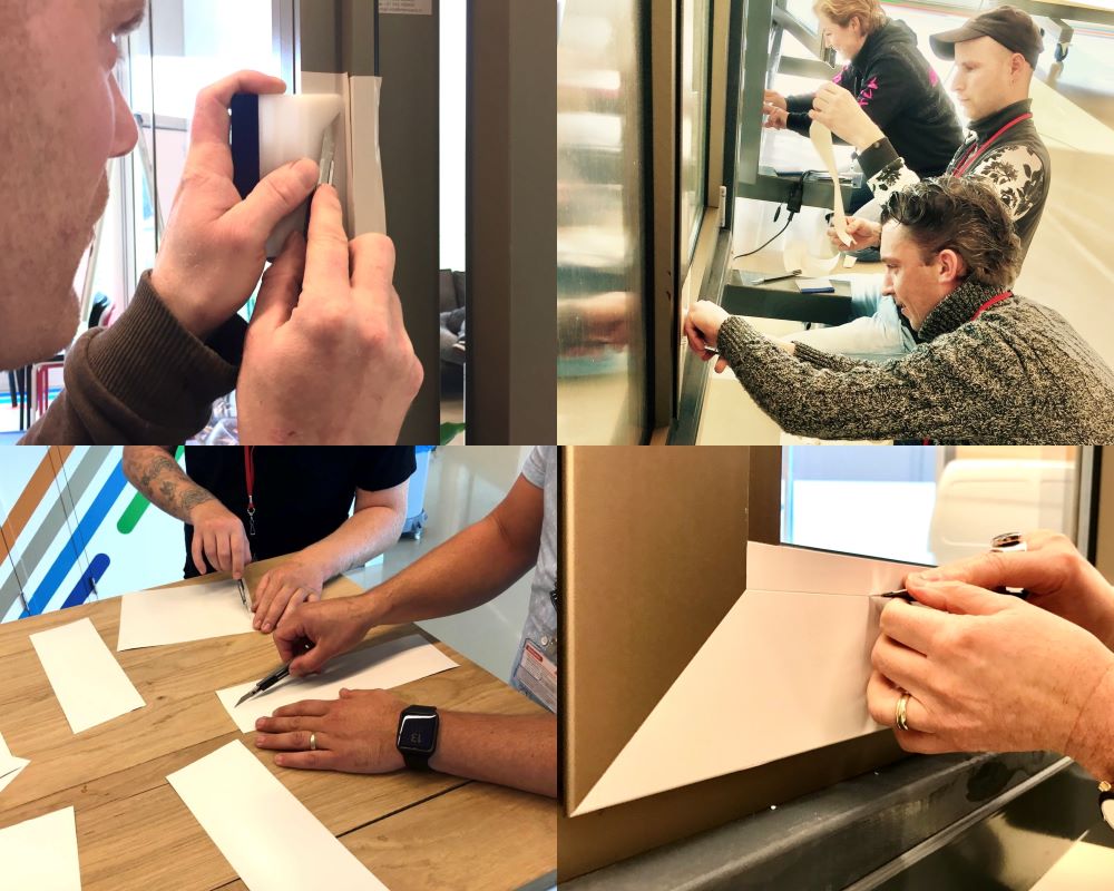 Cursisten doen verscheidene praktijkoefeningen met kozijnfolie tijdens “Schilderen met folie” Facadefilm training opleiding